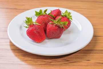 Fresh strawberry on a white plate