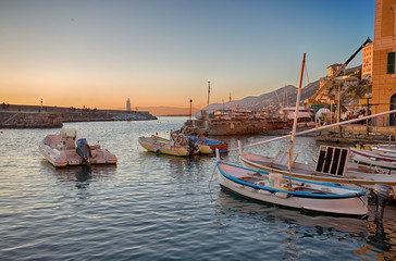 Fototapeta premium CAMOGLI, ITALY, JANUARY 13, 2018 - View of marina of Camogli with lighthouse at sunset, Genoa (Genova) Province, Liguria, Mediterranean coast, Italy