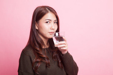 Young Asian woman with a glass of drinking water.