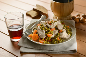 boiled chicken with a side of peas and carrots