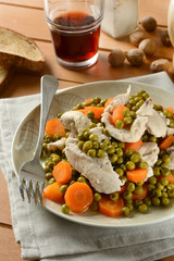 boiled chicken with a side of peas and carrots