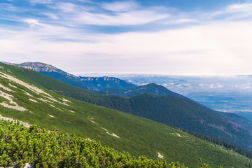 View from the ridge of the High Tatras National Park in Slovakia to the mountain landscape with hills and valleys.