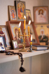 candle against the background of orthodox icons