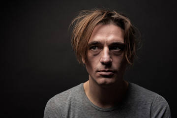 Portrait of unhappy hophead standing and looking aside with melancholy. Isolated on background