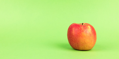 red apple on green background panorama