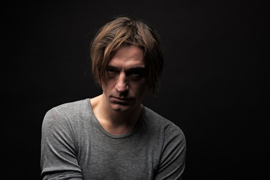 Portrait of addicted looking at camera with frustration. Copy space in right side. Isolated on background