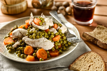 boiled chicken with a side of peas and carrots