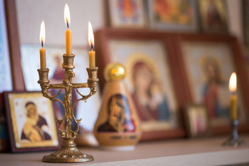 candle against the background of orthodox icons