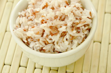 mixed red cargo rice in cup on bamboo plate