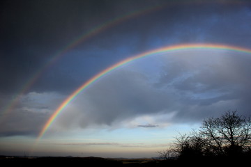 Double rainbow over landscape. Czech Republic.