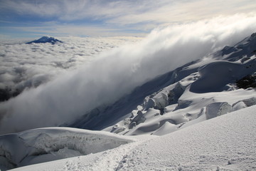 Panoramic view over the clouds from the summit of the active volcano Cotopaxi, Ecuador