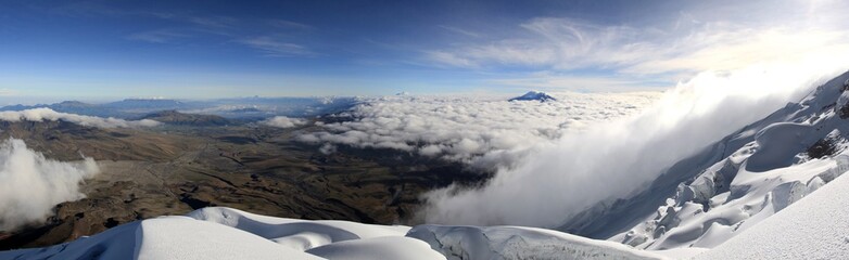 Naklejka premium Panoramic view over the clouds from the summit of the active volcano Cotopaxi, Ecuador