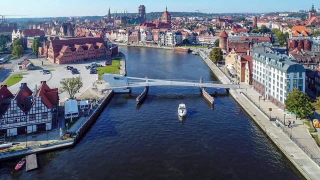 Gdansk, Poland. Aerial  4K video of old old city, Motlawa river, drawbridge and all famous monuments: medieval crane (Zuraw), St Mary, St John churches, city hall tower, old houses,  philharmonic hall