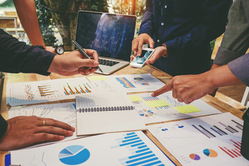 Startup business team colleagues meeting Planning Strategy Analysis discussing new plan financial on graph data new business project