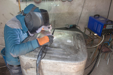 Worker welding aluminum using tig welder