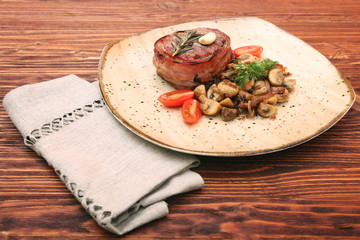 Tasty Beef steak with mushrooms and herbs on plate