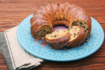 Bundt Cake with Sugar Icing on a wooden background