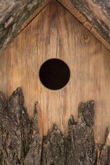 design, arts and crafts, environment concept. this nesting box looks very natural and melds with the landscape of the park or forest because of its decor crafted of wood bark