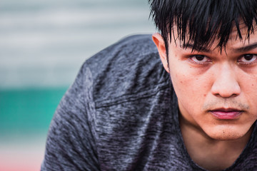 Asian man preparing to run