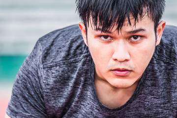 Asian man preparing to run