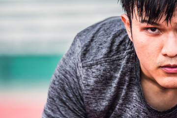 Asian man preparing to run
