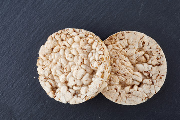crispbread on stone plate. Dark stone background. Copyspace for text.