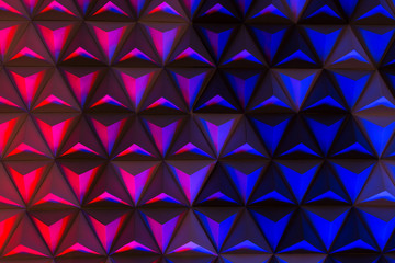 color pallet, illumination, decor concept. multicolored background of the stage in modern theater created with lots of pyramids made of cardboard and illuminated from below
