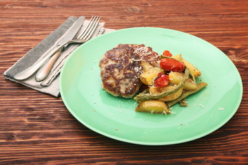 chicken cutlet, baked potatoes and vegetables