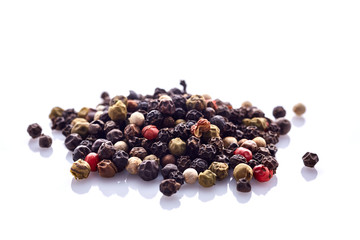 Seasoning - four kinds of pepper peas - isolated on white background