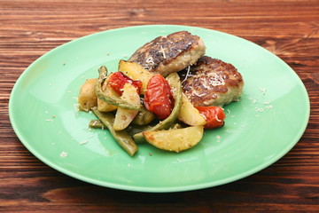 chicken cutlet, baked potatoes and vegetables