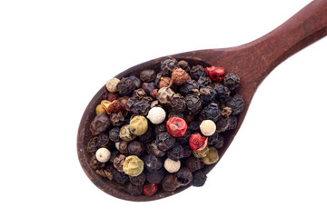 spices in the spoons isolated on white