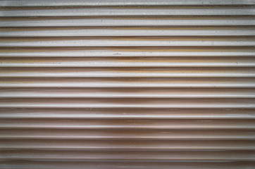 Obraz premium Teal brown painted horizontal metal window roller shutter blinds or garage doors background texture