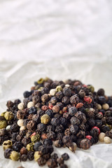sweet-scented black pepper peas in bulk on white crumpled paper. top view
