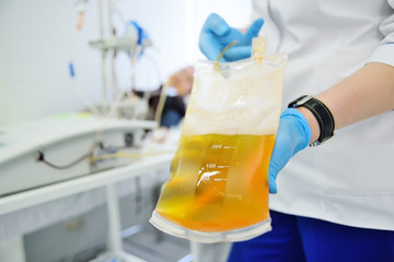 plasma in a plastic bag in the hands of a nurse