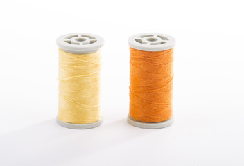 Colored sewing thread white background