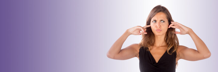 Beautiful girl with her hands covering her ears; isolated photo with copy space