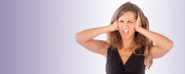 Beautiful girl with her hands covering her ears; isolated photo with copy space