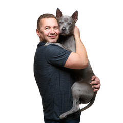 man holding thai ridgeback dog
