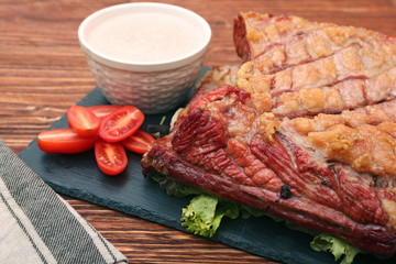 Delicious smoked beef ribs on an old rustic wooden chopping boar