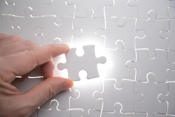  jigsaw puzzle piece with light glow, business concept for completing the final puzzle piece