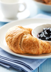 Croissant with blackberry marmalade on a plate