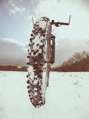 Cyclist on Mountain Bike on the Snowy Hill. Landscape  Covered with Fresh Snow.
