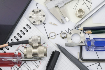 Engineering and technology background with components, records and tools illustrating research and development process.in applied science and engineering.