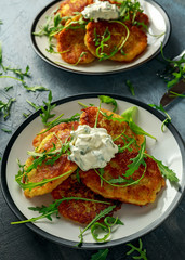 Potato pancakes, draniki, hash browns or fritters served with... fresh wild rocket leaves salad.