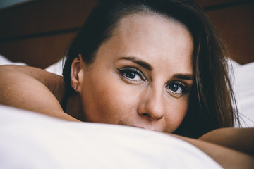 Fototapeta na wymiar Portrait of a young woman in bed