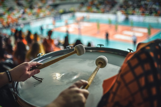 Drum of supporters  and volleyball court in the background.