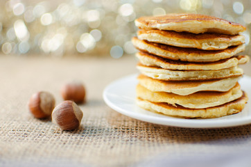 Fried pancakes are a mountain on a plate of sweets