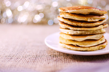 Fried pancakes are a mountain on a plate of sweets