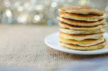 Fried pancakes are a mountain on a plate of sweets
