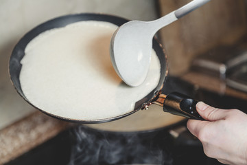 liquid dough is poured onto frying pan